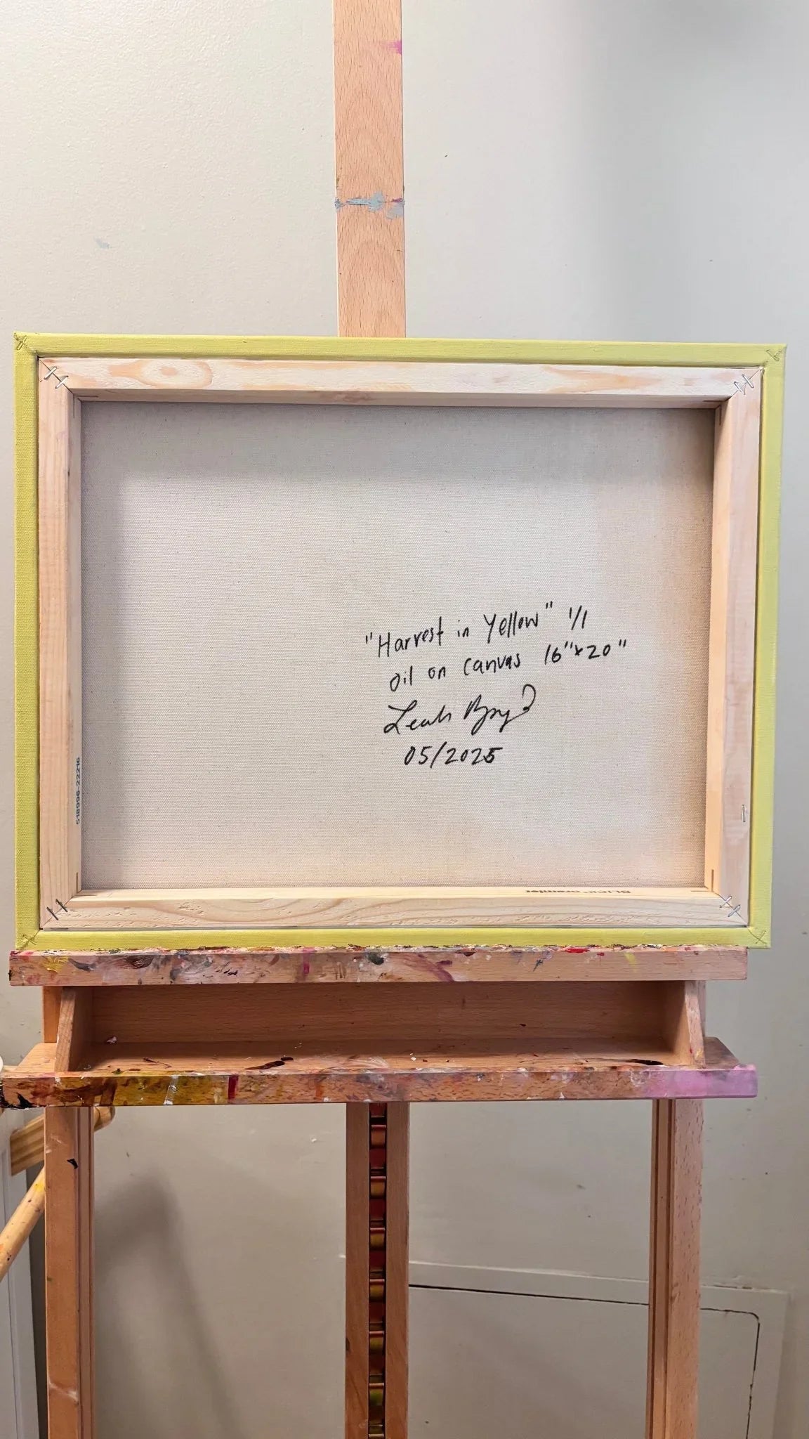 The original oil painting, "Harvest in Yellow" by Leah Boyd, is signed on the back and comes stretched, secured in a wooden frame with a yellow border.