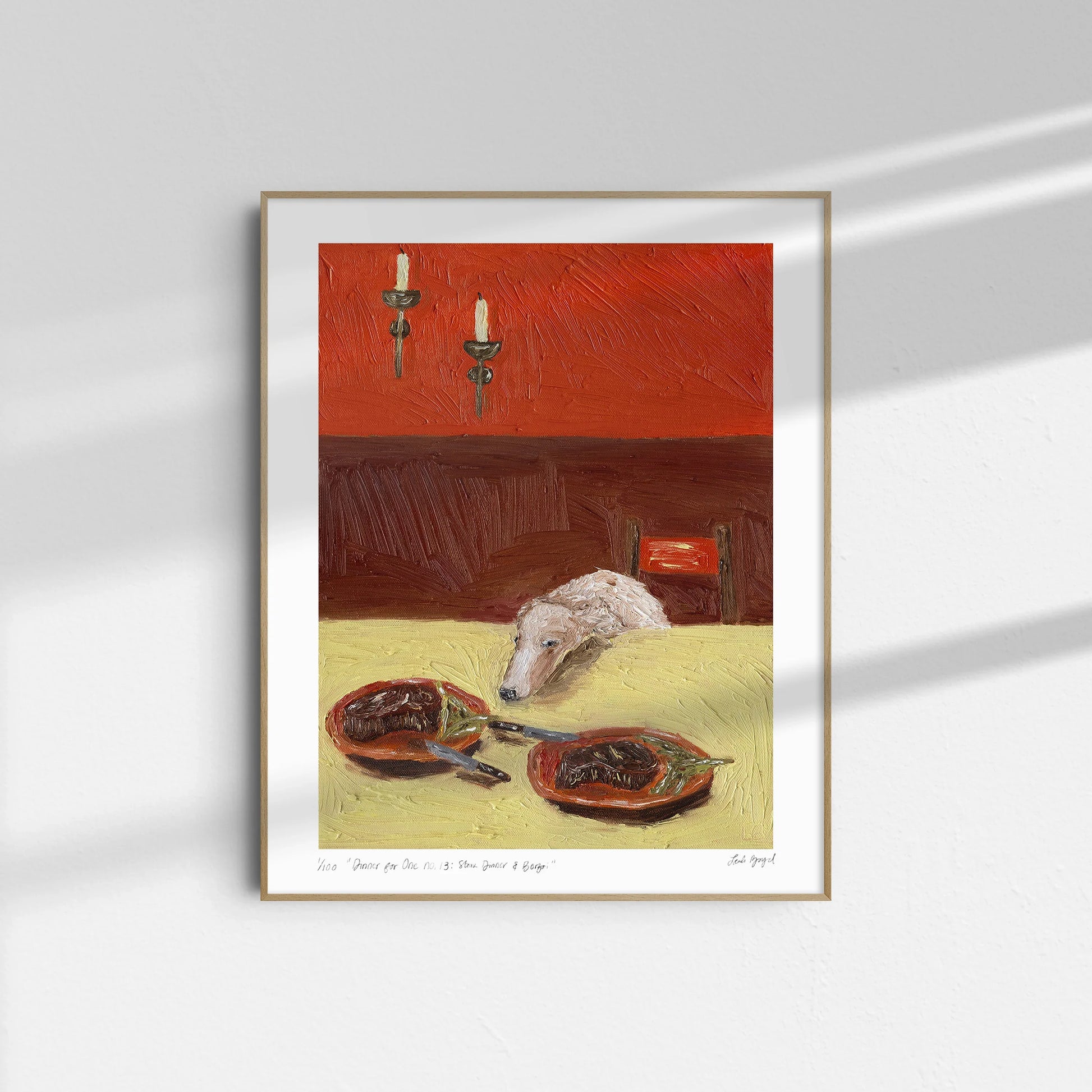 Dinner for One no. 13: Steak Dinner & Borzoi by Leah Boyd is a limited edition Giclee print featuring a dog's head on a yellow table with steak plates, two unlit candlesticks, and soft natural light against a deep red wall.