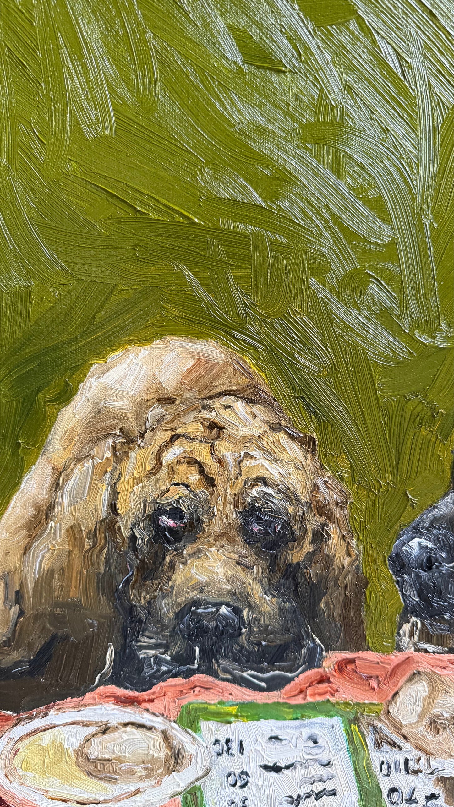 An original oil painting titled “Complimentary Bread” by Leah Boyd, featuring a sad-looking brown dog with droopy eyes sitting at a table set with plates of food and a menu, all against a textured green background—perfect for any canvas art collection.