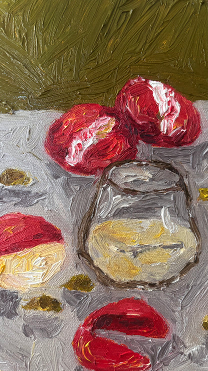 Memories of My Mother" by Leah Boyd is a signed original oil painting depicting red and white round fruits, a sliced fruit, and a glass with yellow liquid on textured gray, set against an expressive green background.