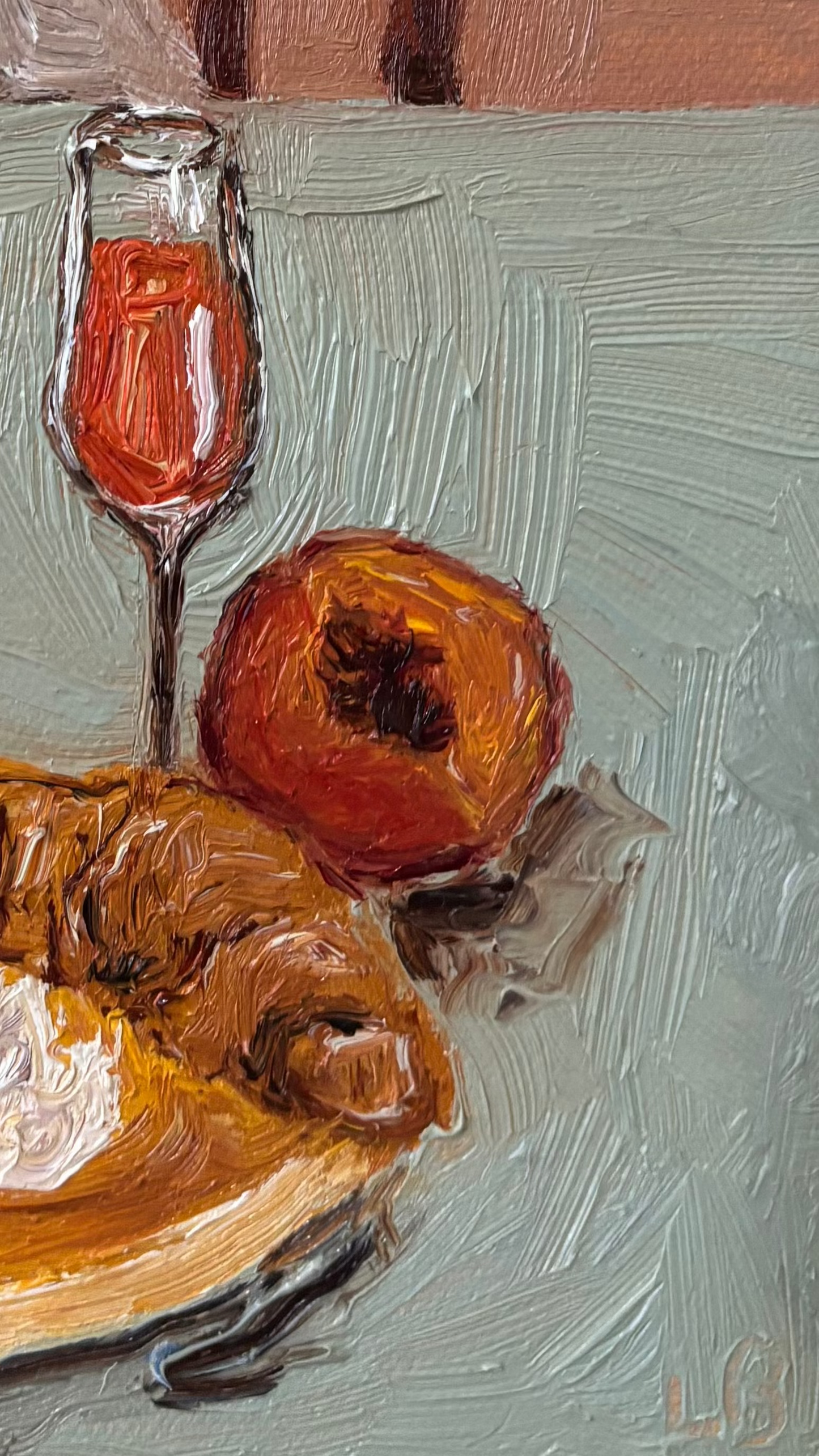 A close-up of Leah Boyd's "Sunny Mornings" shows a glass of pink liquid, a red pomegranate, and a golden-brown pastry on a plate, all arranged on a textured light blue surface.