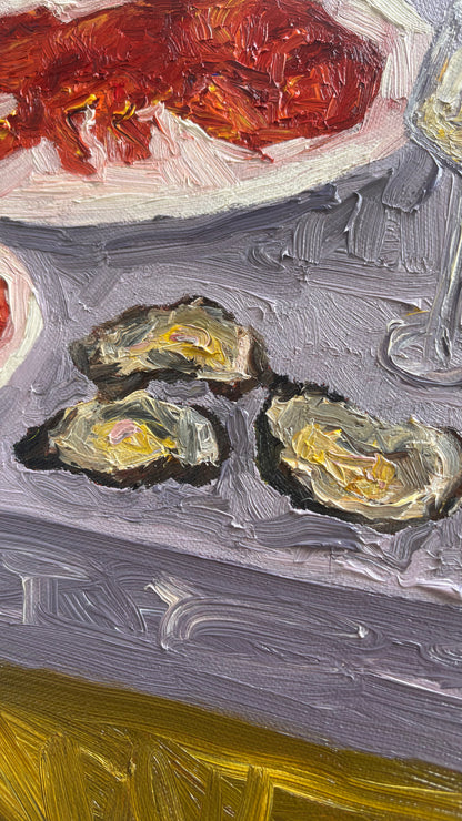 Close-up of "The Kids Table" by Leah Boyd—original oil painting featuring three oysters on a gray table, a lobster on a white plate, and a wine glass. Thick brushstrokes. Canvas art includes certificate of authenticity.