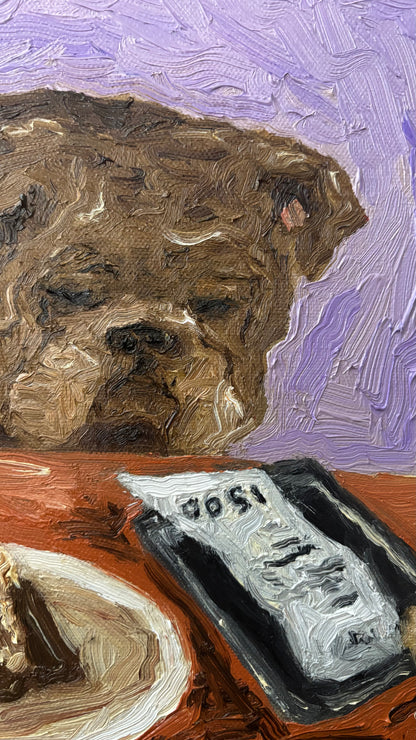 “Yikes” by Leah Boyd is an original oil painting of a brown dog with closed eyes at a table with food and a restaurant bill, set against a purple background. Presented in a walnut floater frame with certificate of authenticity included.
