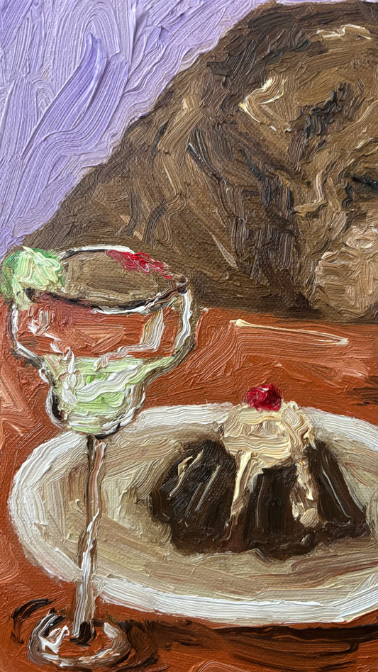 Yikes by Leah Boyd: An impressionist oil painting of a margarita glass with lime and cherry-topped dessert set against a purple sky and brown mountain. Includes certificate of authenticity; walnut floater frame available.
