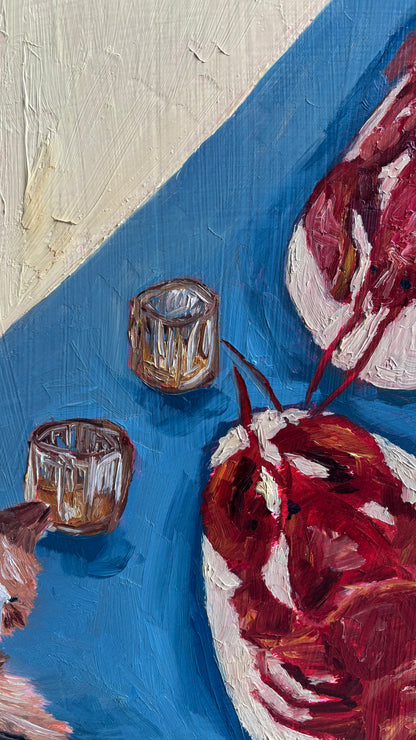 A close-up of "Whiskers, Whisky, and Lobster" by Leah Boyd shows two short glasses and a red lobster on a blue and cream background, painted with bold textured brushstrokes and vivid colors on cradled wood panel.