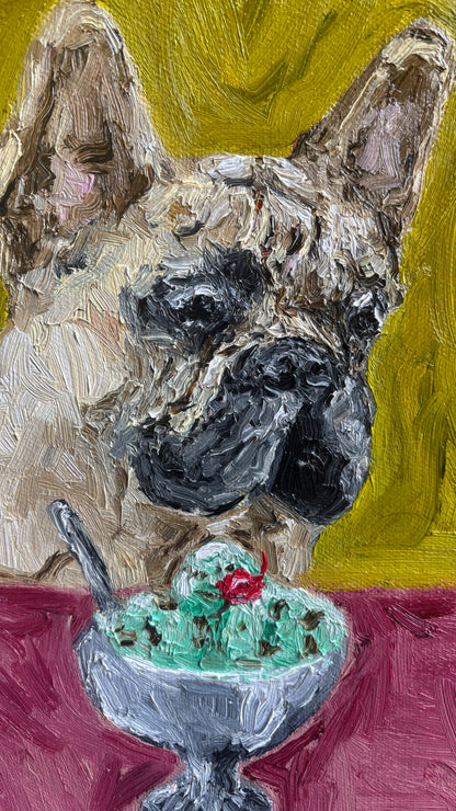 Bring playful charm and vibrant color to any space with “À la mode” by Leah Boyd—a textured, original oil painting featuring a brown French bulldog gazing at a dish of mint chocolate chip ice cream topped with a cherry against a sunny yellow background. This signed canvas artwork is perfect for lovers of unique art.
