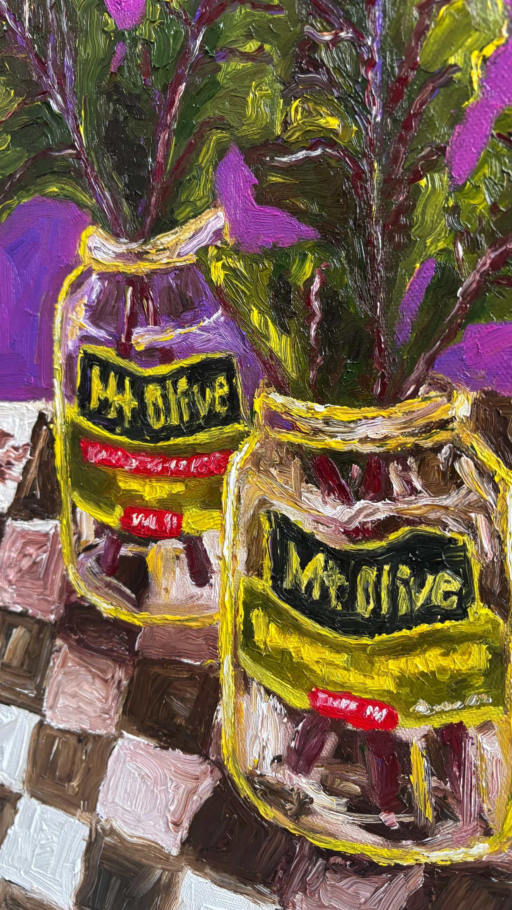 Leah Boyd’s vibrant oil painting, "Mt. Olive Pickles and Collard Greens," features two Mt. Olive jars with leafy greens on a checkered surface against a purple backdrop. Paint application is thick and textural.