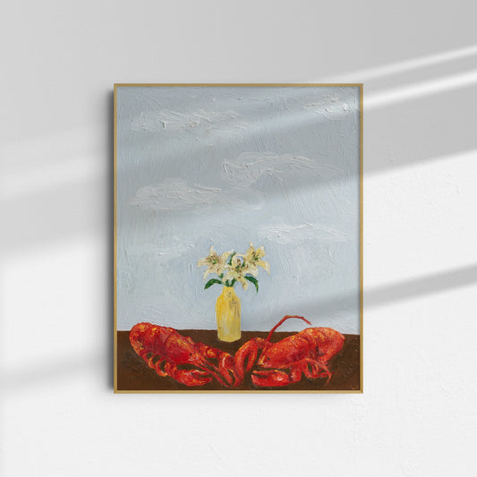‘Til Death Do Us Part or Consider the Lobster’ by Leah Boyd, a framed art print featuring a red lobster on a table with a yellow vase and white flowers against a cloudy blue sky, hangs on a white wall with shadows.