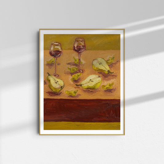 Pears & Pepperoncini" by Leah Boyd: a framed giclee print featuring two glasses of red wine and pears with leaves on a warm background, hung on a white wall where sunlight casts gentle shadows.