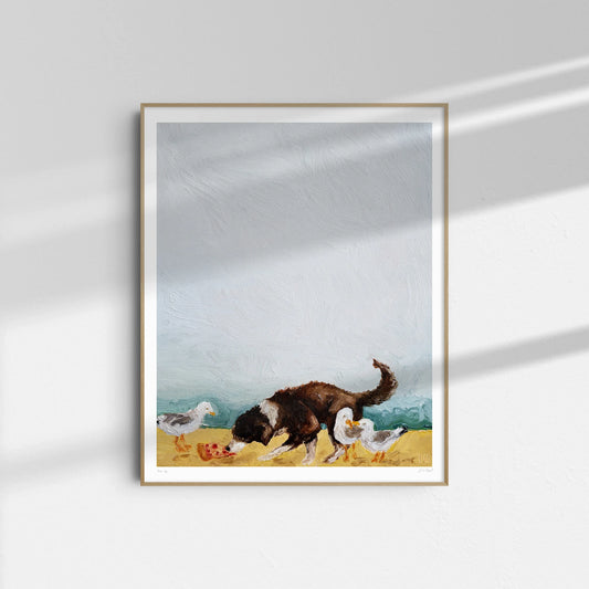 “Beach Day” by Leah Boyd is a framed Giclee print featuring a black and brown dog sniffing the sand among three white seagulls—ideal beach art for any room.