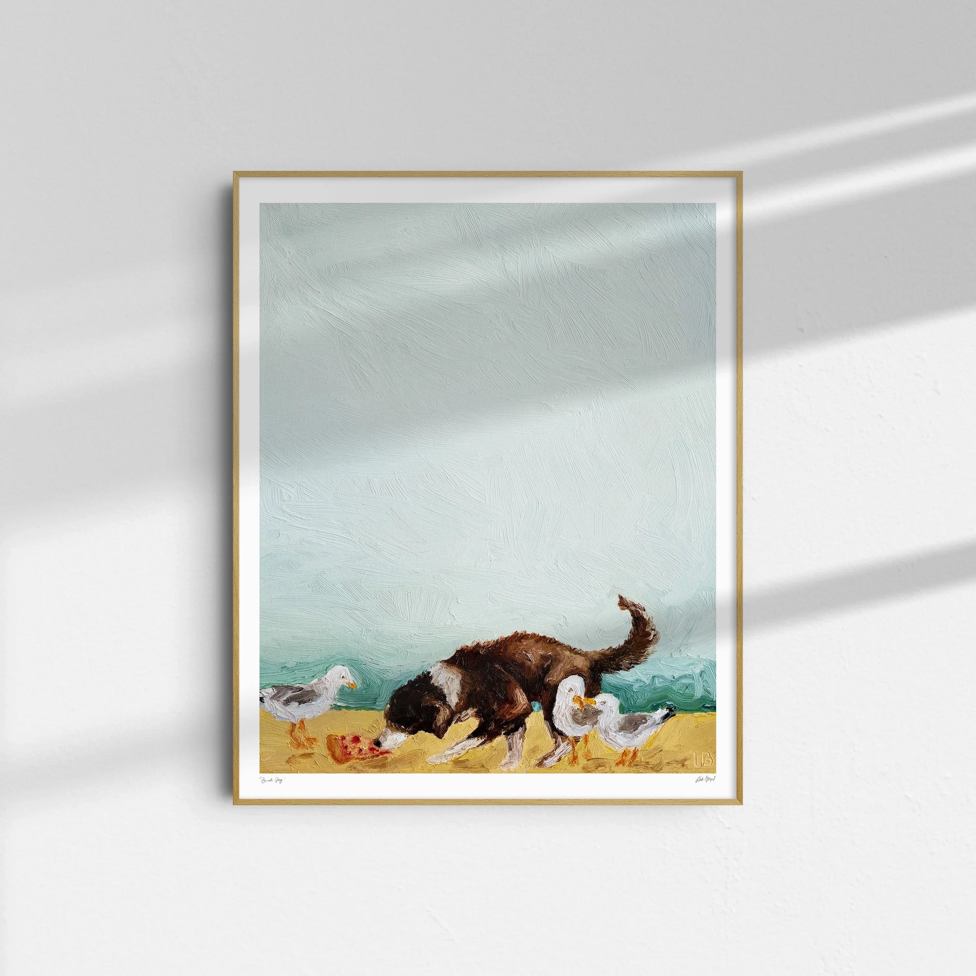 Beach Day" by Leah Boyd is a framed oil on canvas featuring a dark brown and white dog sniffing the ground beside three white birds, displayed against a light wall with gentle shadows.